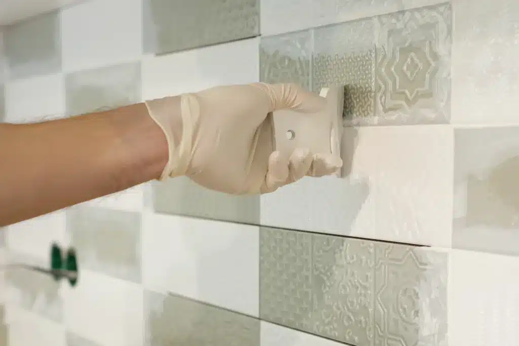 3 Frequently Asked Questions About Putting Epoxy on Tile Closeup of tiler hand rubbing tile, Installing and grouting decorative finishes in environments with an high aesthetic value. Two-component, decorative, acid resistant epoxy grout. epoxy on tile