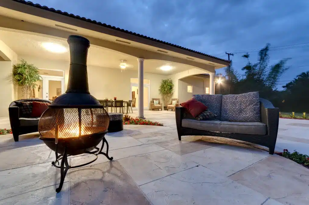 Perfect Your Patio in Summer with These 7 Tips Fire pit in a modern backyard with patio furniture. Your Patio in Summer